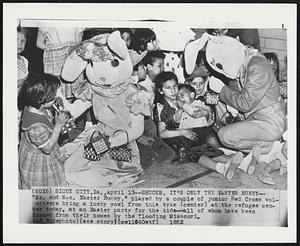 Shucks, It's Only the Easter Bunny-- "Mr. and Mrs. Easter Bunny," played by a couple of junior Red Cross volunteers bring a lusty yowl from this tyke (center) at the refugee center today, at an Easter party for the kids--all of whom have been forced from their homes by the flooding Missouri.