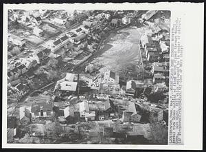 Where Flood Came Through Norwich-- Aerial view shows outline of flood which ripped through Norwich, Conn., last night. Mill which collapsed is in center of picture.