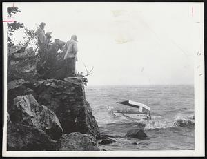 Hurricane Spectators watch 25-foot lobster boat break up today on Squantum rocks.