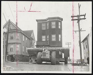 House Moving is Easy Now, as shown by this trucking of a house along Clark avenue, Chelsea, yesterday on a specially constructed house moving vehicle. The house was in the path of the approaches to the new Mystic River Bridge.