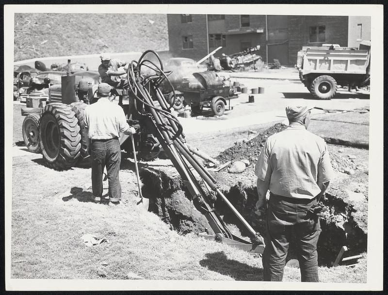 Providing Water for destroyed section of a tornado-wrecked Worcester Housing Authority project, workmen dig a hole for a new hydrant.