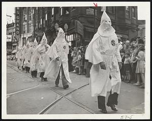 Klansmen on the March Robed and hooded members of the Ku Klux Klan are shown marching through Atlanta, Ga., streets, April 26, during the memorial day parade in tribute to veterans of the southern confederacy. The marchers wore regalia similar to that of the original Ku Klux Klan which was founded during the stormy reconstruction days just after the war between the states.