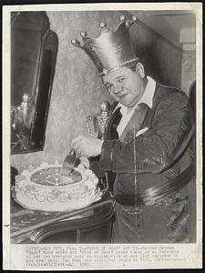 'King of Swat' Now 51 -- George Herman "Babe" Ruth wears his "King of Swat" crown today as he prepares to cut out the birthday cake in celebration of his 51th birthday at his home here. The Babe was given the crown in 1921.