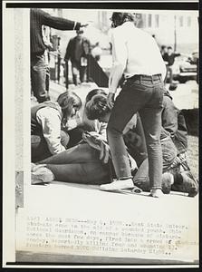 Akron, Ohio - May 4, 1970 - Kent State Univer. students came to the aid of a wounded youth. Ohio National Guardsmen, on campus because of disturbances the past few days, fired into a crowd of students Monday, Reportedly killing four and wounding 13. Prosters burned ROTC Building Saturday Night.