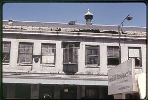 Dilapidated Quincy Market, sign reading "Faneuil Hall Marketplace, Inc." in foreground