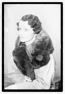 A woman with a fur scarf around her neck