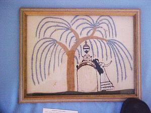 Framed textile of a willow tree and woman by a gravestone