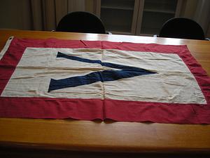 Banner with white ground bearing a blue V