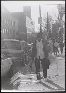 Young man standing on the sidewalk