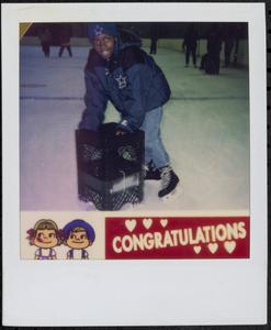 Boy ice skating with milk crates
