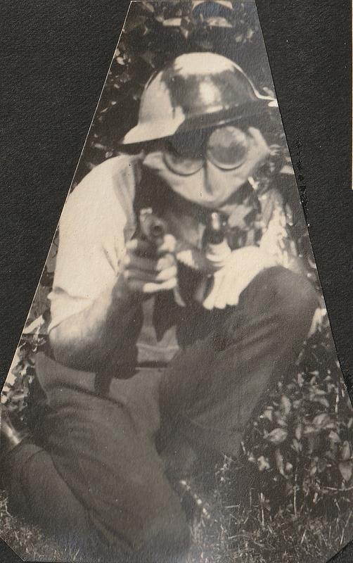 Man in gas mask holding two pistols, West Yarmouth, Mass.