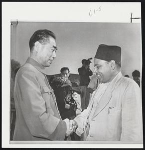 Getting Ready to Talk Money--Red China Premier Chou En-lai, left, greets Prime Minster Archarya of Nepal on his arrival in Peiping on an official visit. Radio Peiping yesterday announced that China will give the Himalayan kingdom about $12,650,000 in economic aid.