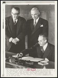 NATO Architect Dies-Dean Acheson, secretary of state during the turbulent years after World War II and architect of much of U.S. Cold War strategy, signs the North Atlantic Treaty Organization pact on April 4, 1949 as then President Harry Truman, standing right, and Vice President Alben Barkley, left, watch. The veteran diplomat died at his Sandy Spring, Md., farm Tuesday.