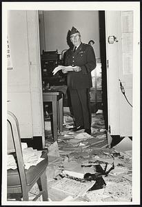 Paint-spattered draft records strewn on floor