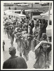 Spectators applaud as Veterans walk into Concord District Court with hands over their heads.