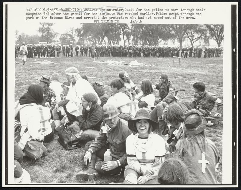 Antiwar demonstrators wait for the police to move through their ...