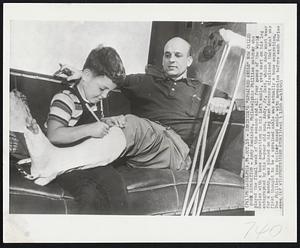 Seminick's "Sprained Ankle" Now Called Bone Separation- Andy Seminick, Philadelphia Phillies catcher who played the final week of the season and all four games of the World Series with a bone separation in his left ankle, gets cast on his left autographed by his 4-year old son, Andy, Jr. Cast, which Andy must wear for a month, was placed on his leg when doctors disclosed that what was first thought to be sprained ankle was actually a bone separation. The Phillies team trainer dosed ankle with novocaine before each Series game.