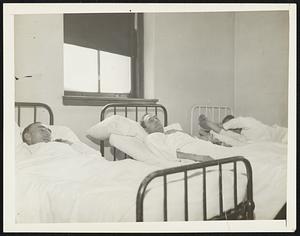 Will They Escape "Creeping Death". Three victims of poison liquor epidemic which has claimed 31 lives in Mohawk Valley shown in isolation ward of hospital at Gloversville, N.Y., Jan. 30. several victims have died after being discharged from hospital apparently cured. Will these unnamed men survive of succumb is question yet to be answered.