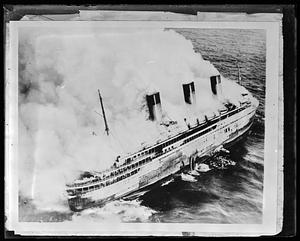French liner SS Atlantique on fire off Guernsey, England