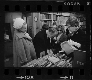 Famed comedian Red Skelton takes time to do some shopping in a book store at Kingston and Bedford Sts.