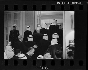 Men wearing bisht over thawb entering the Sheraton