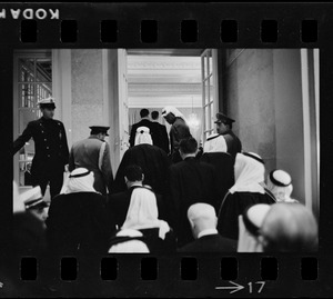 Men wearing bisht over thawb entering the Sheraton ballroom