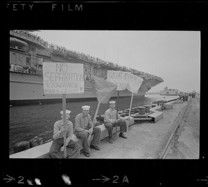 Sailors holding handmade signs