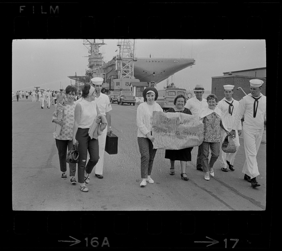 Group leaving the Aircraft Carrier Wasp uses this sign to express sentiments over being unexpected guests on the giant warship as it docked at the Naval Air Station in Quonset Point, RI