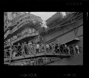 Men and women walking off ship