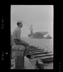Sailor waiting on dock for USS Wasp to anchor