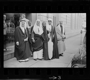 Group of men wearing bisht over thawb outside Sheraton Plaza Hotel