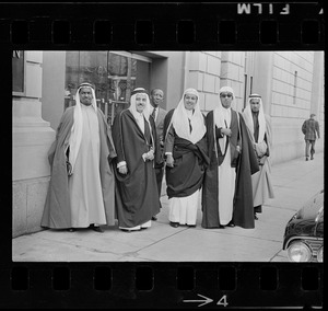 Group of men wearing bisht over thawb outside Sheraton Plaza Hotel