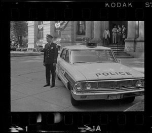 Officer standing next to police car