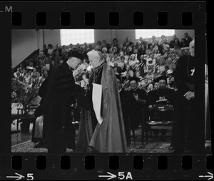 Governor John Volpe, Senator Edward Kennedy, and Mother E.M. O'Byrne, seen on stage at Boston College commencement