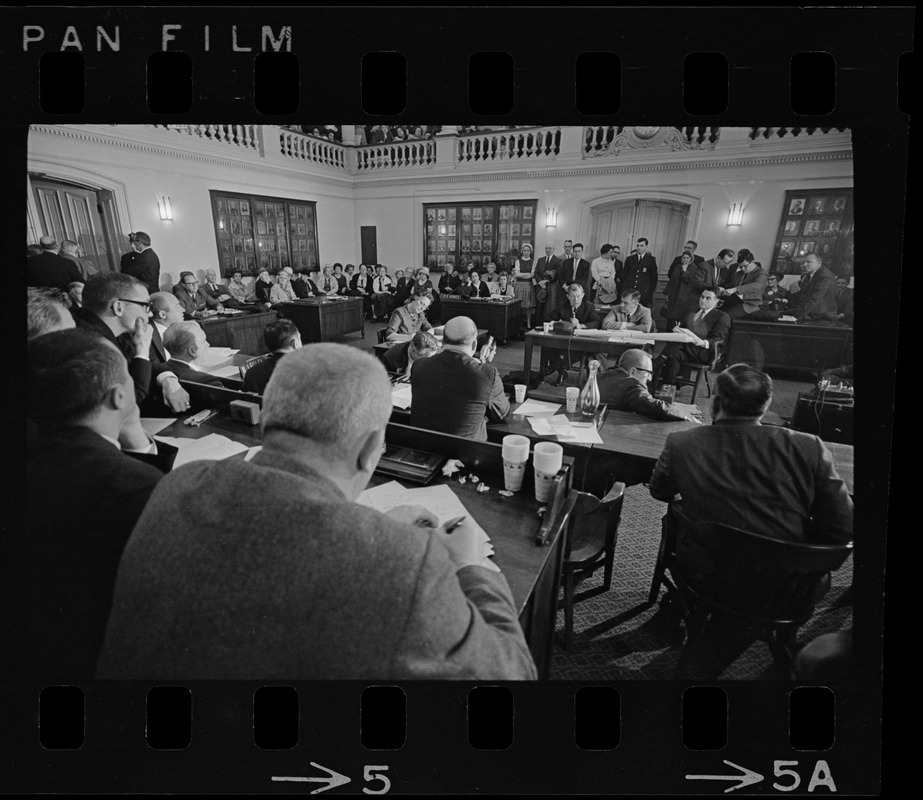 City Council members sitting at tables arranged in a horseshoe at ...