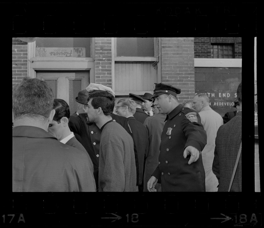 Policeman outside Boston Redevelopment Authority South End office officer sit-in