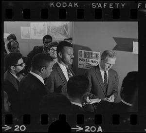 A man speaking while Mayor Kevin White and others stand nearby during Boston Redevelopment Authority sit-in