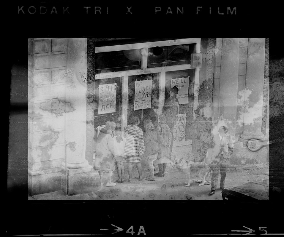 People looking into Boston Redevelopment Authority South End office window during sit-in