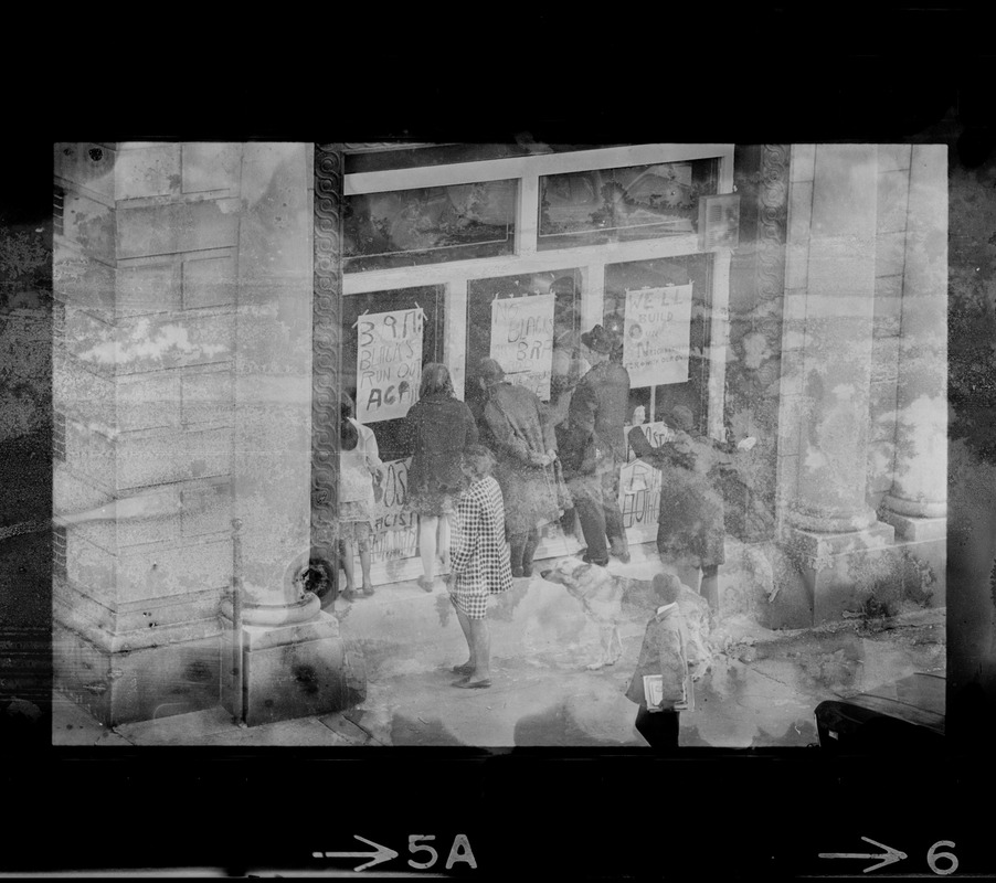 People looking into Boston Redevelopment Authority South End office window during sit-in