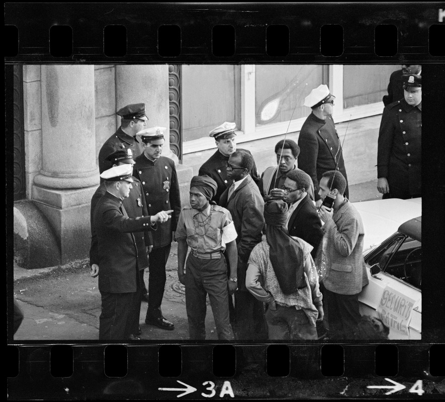 Police officers talking to people outside Boston Redevelopment Authority South End office