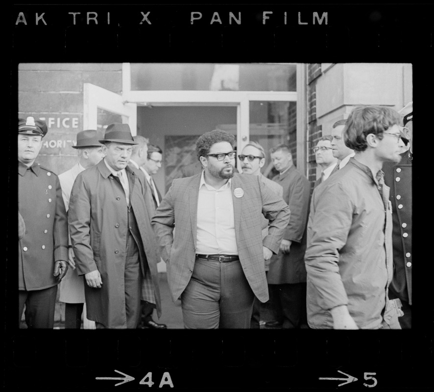 Man with glasses exiting Boston Redevelopment Authority office during BRA sit-in