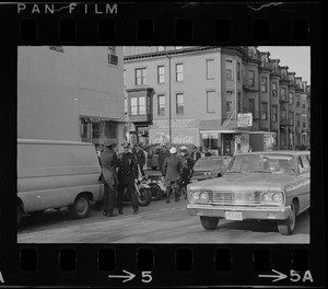 Police officers and cars seen on a street during Boston Redevelopment Authority sit-in