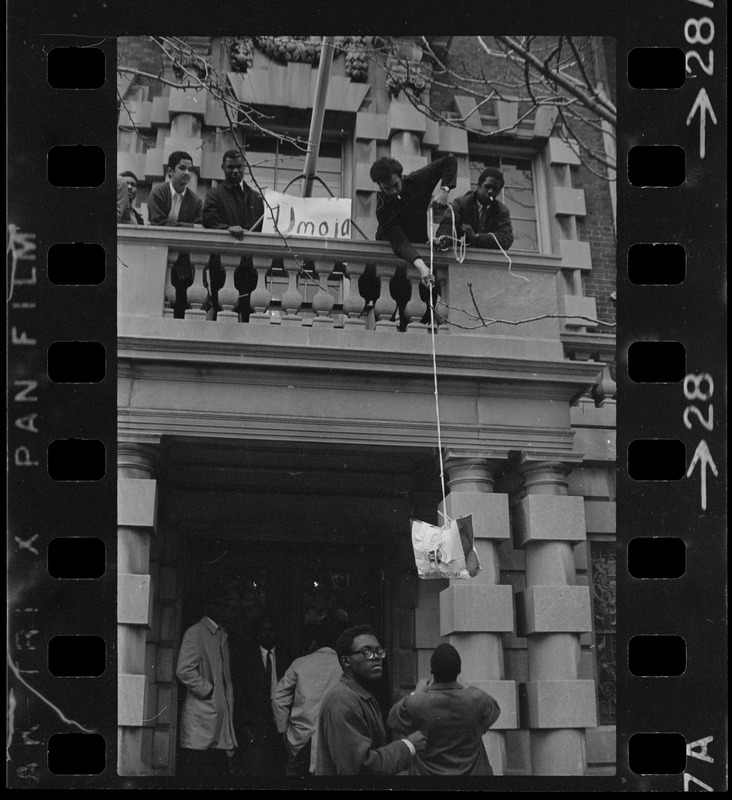 Students involved in sit-in hoist a bag up to balcony of Boston University administration building