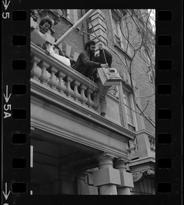 Students involved in sit-in hoist a television up to balcony of Boston University administration building