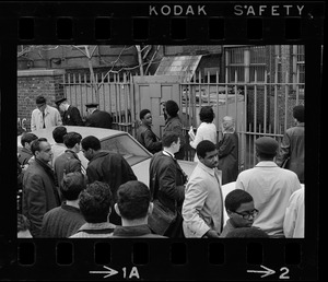 People gathered around rear gates of Boston University building