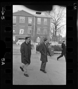 Morris B. Abram, right, president of Brandeis University and another man, walking in parking lot at Brandeis University