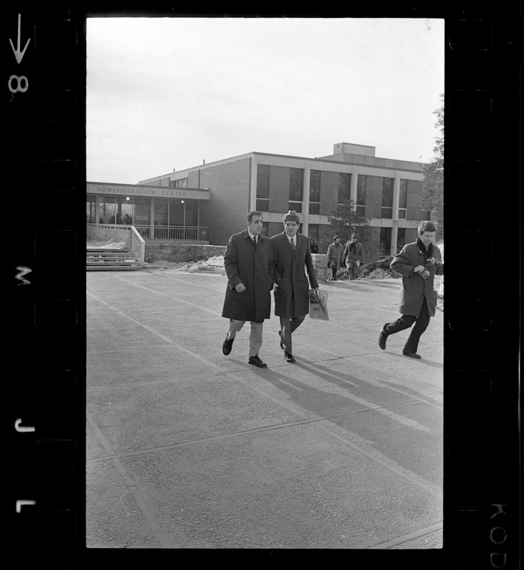 Morris B. Abram, right, president of Brandeis University and another man, walking in parking lot at Brandeis University