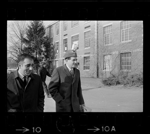 Morris B. Abram, right, president of Brandeis University and another man, walking in parking lot at Brandeis University