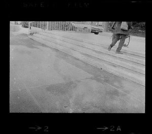 View of man with camera equipment on steps