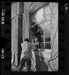 Students climbing into a window at Brandeis University with sign above it that reads "Ford Hall Is Ours Until Demands are Met"